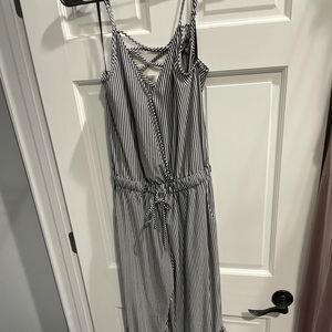 Black and white striped jumpsuit with flared ruffle bottom